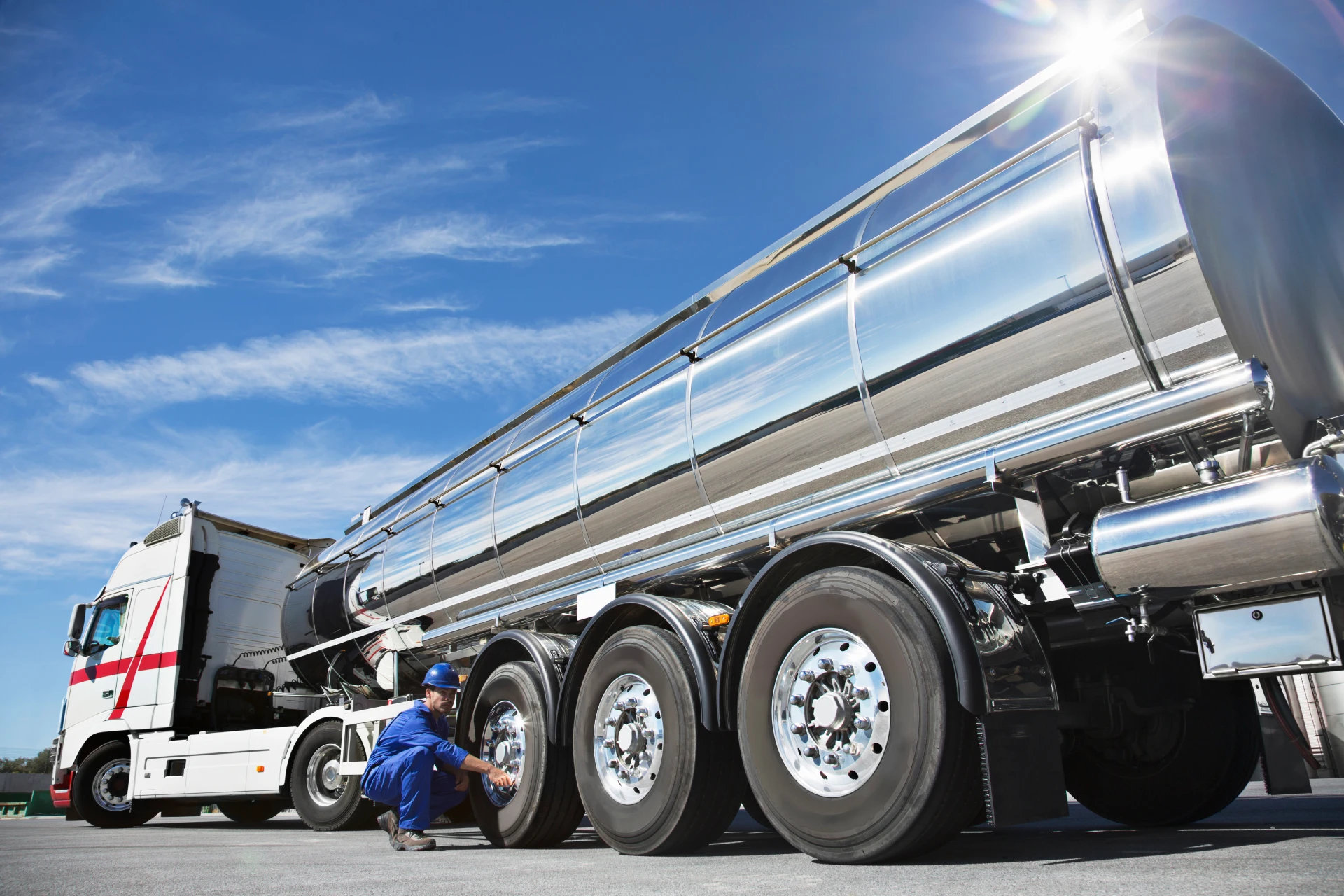 Man fixing a tire on a fuel tanker